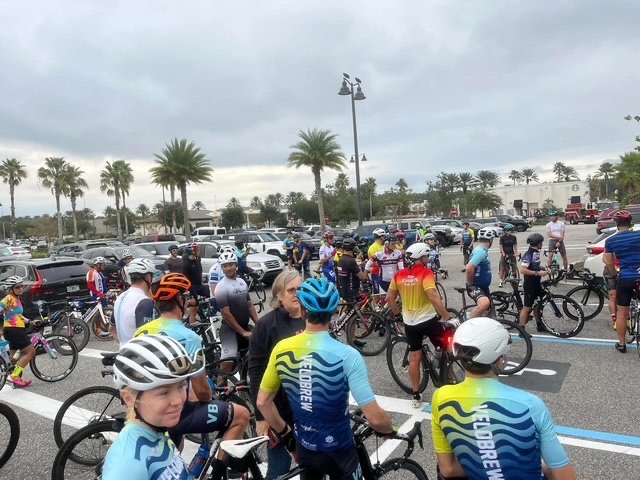 Cyclists gathering in a beachside parking lot before the Tempo Tuesday community ride.
