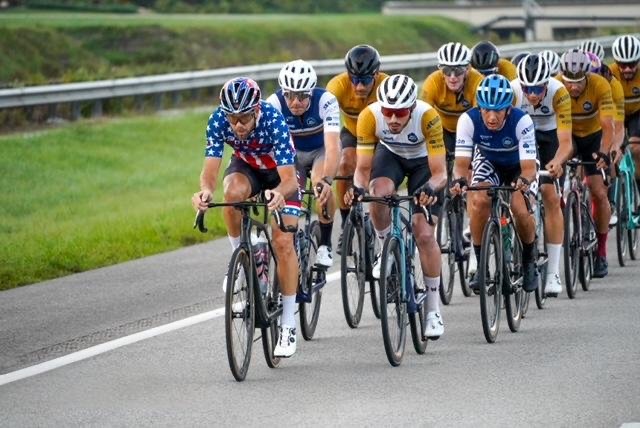 Wednesday Night Worlds paceline at speed, led by a rider in a stars-and-stripes jersey.