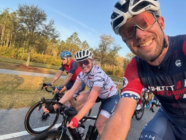 A group of SP athletes smiling for a selfie during a training ride