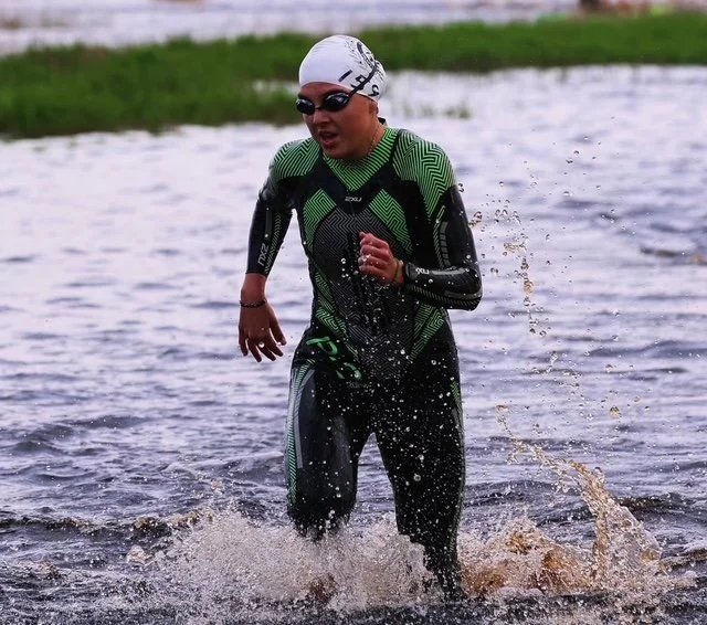 An athlete exiting the water after the IRONMAN Jacksonville swim leg