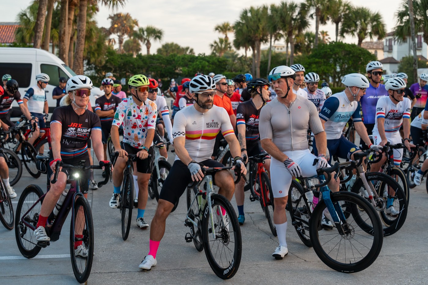Riders gathered at the start on their bikes at dawn, waiting to roll out for a Jax Sub 4 century.